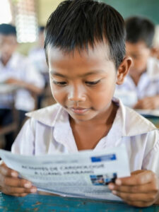 A mother and child sitting together in a serene rice field in Laos, showcasing rural life.